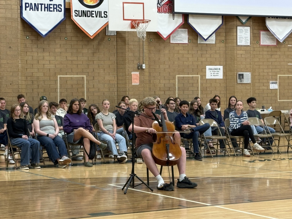 Student playing the cello for the assembly. 