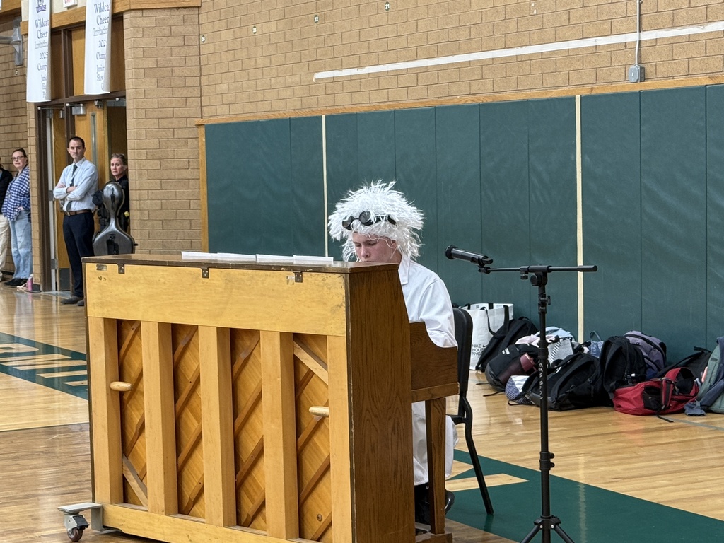 Student playing the piano for the talent assembly. 