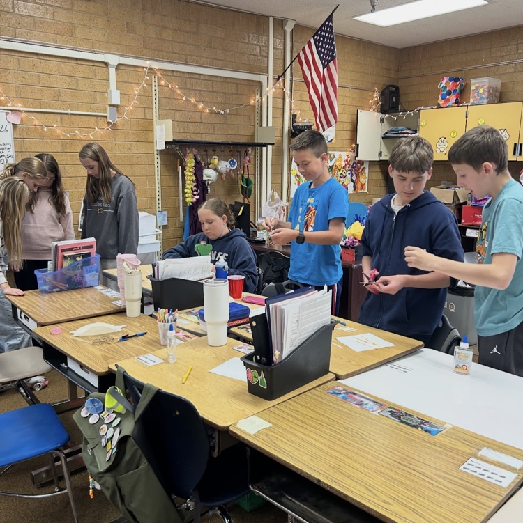 6th graders working as a team to construct bridges as part of a project.
