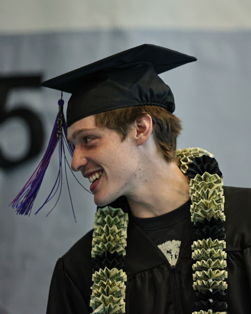 Davis Adult Education graduate smiles as he looks to the left.