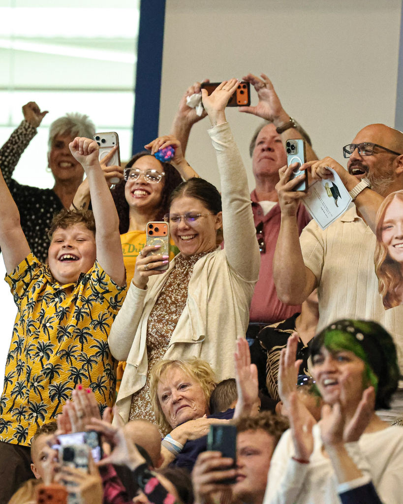 Davis Adult Education graduate family members cheer.