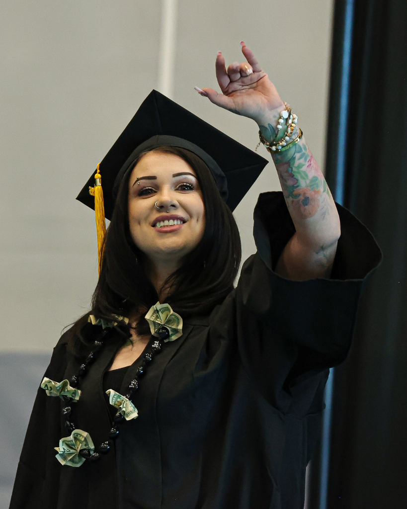 Davis Adult Education graduate waves to family.