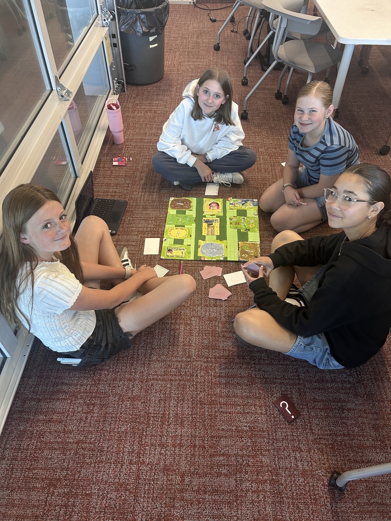 Students pose with their game boards.