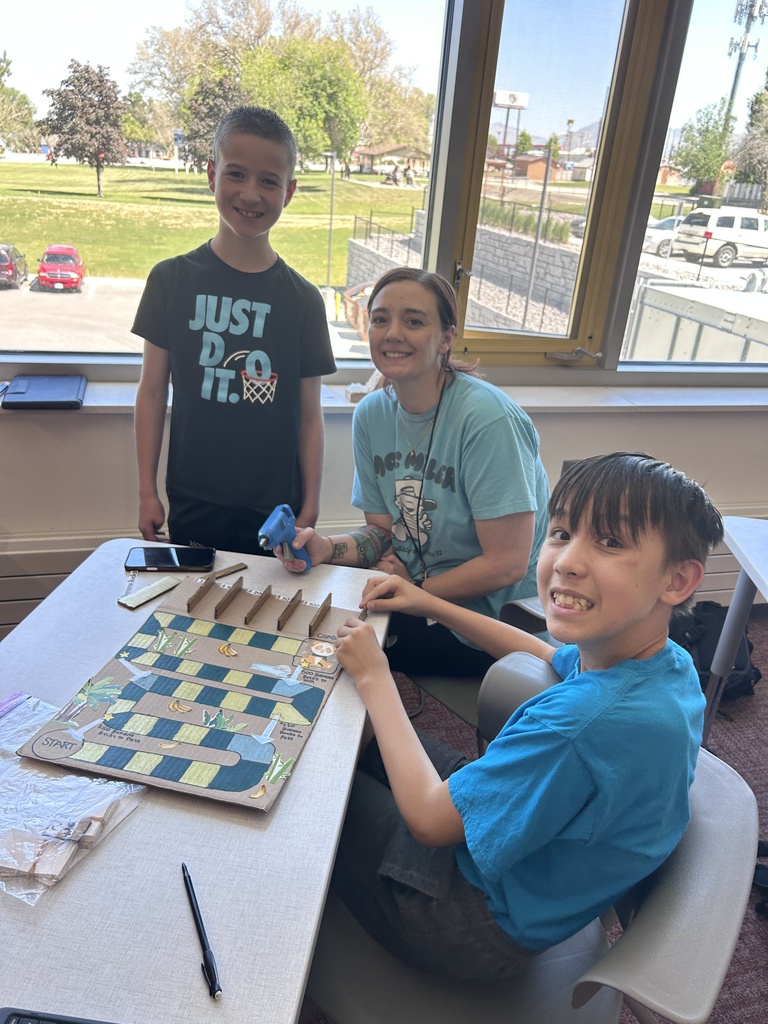Students pose with their game boards.