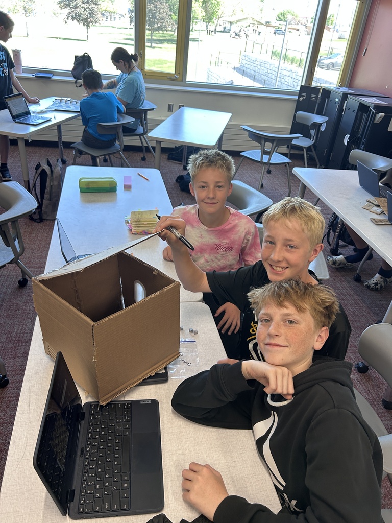 Students pose with their game boards.