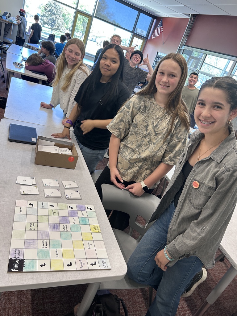 Students pose with their game boards.