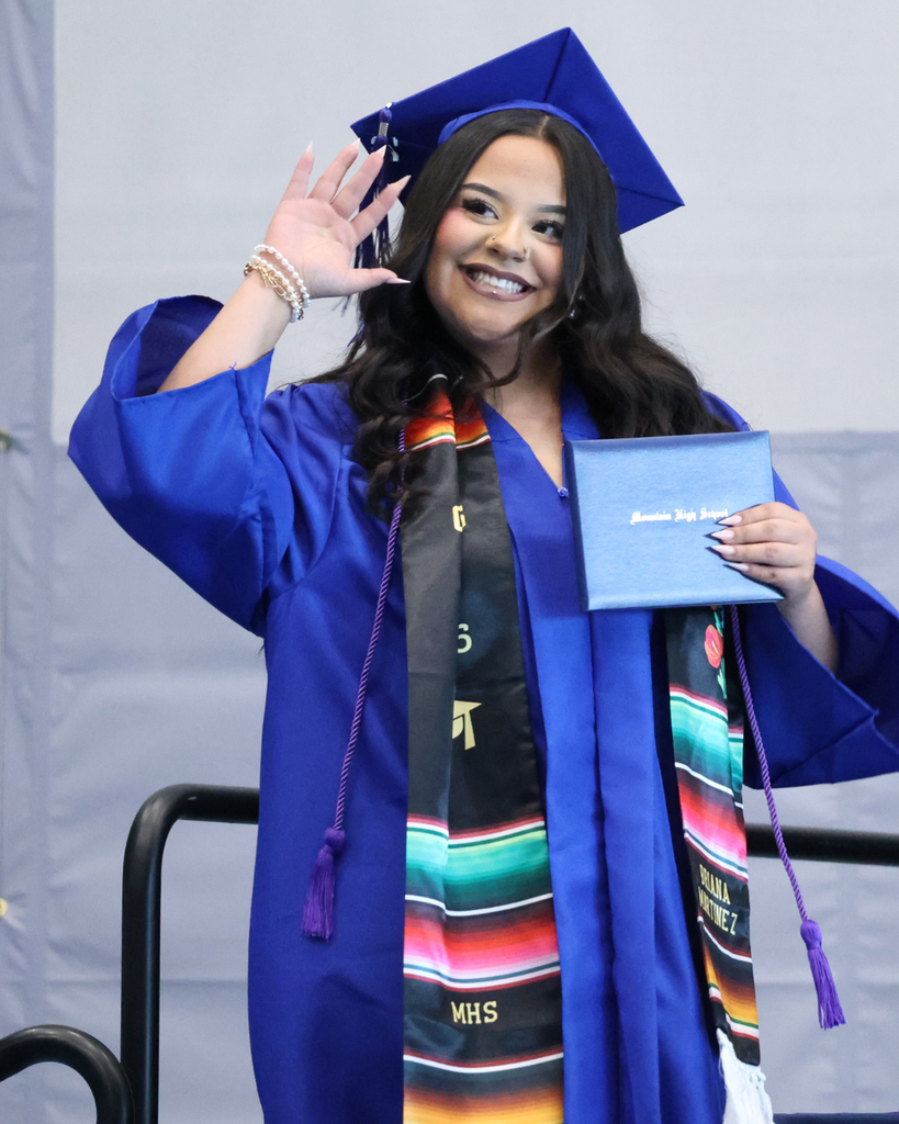 A Mountain High graduate waving and smiling. 