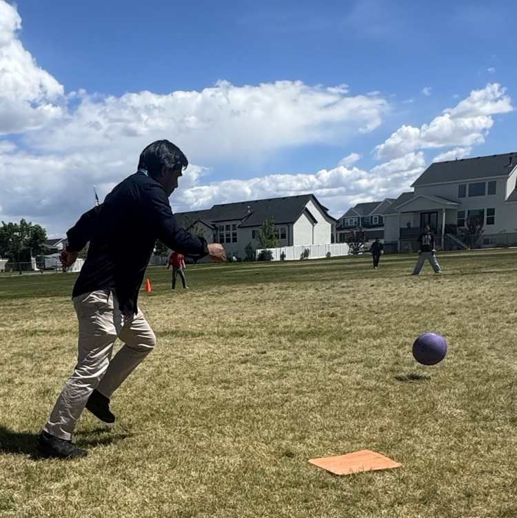 teacher kicking the kickball