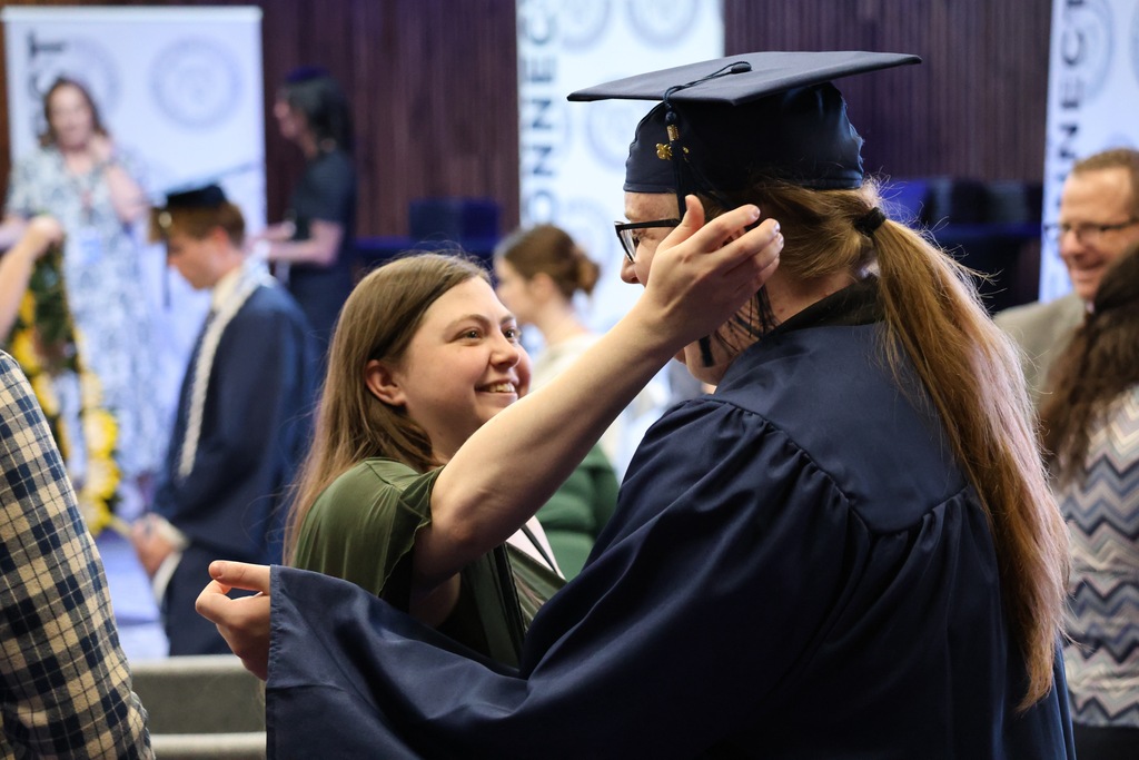 A Davis Connect graduate about to hug a family member. 