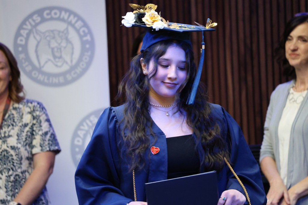 A Davis Connect graduate with a flower cap. 