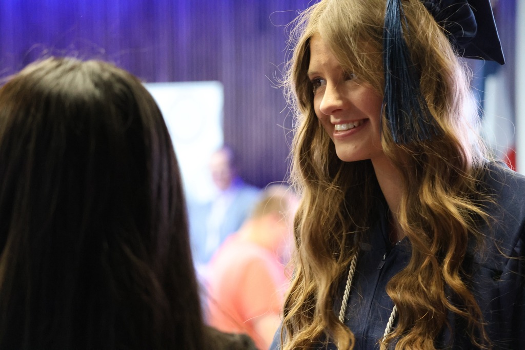 A Davis Connect graduate smiling to the left. 