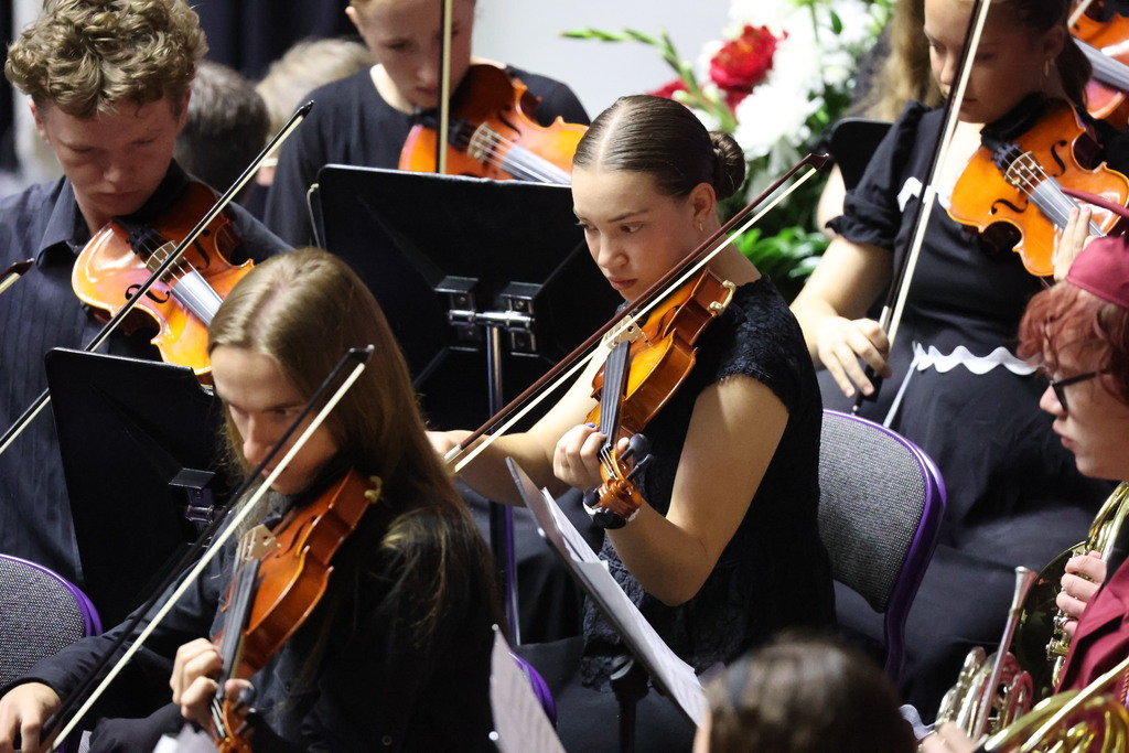 Viewmont High students playing string instruments at graduation.