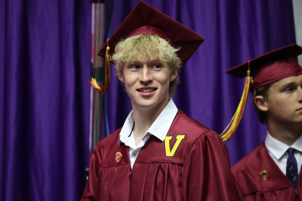 A Viewmont High graduate smiles to the right.