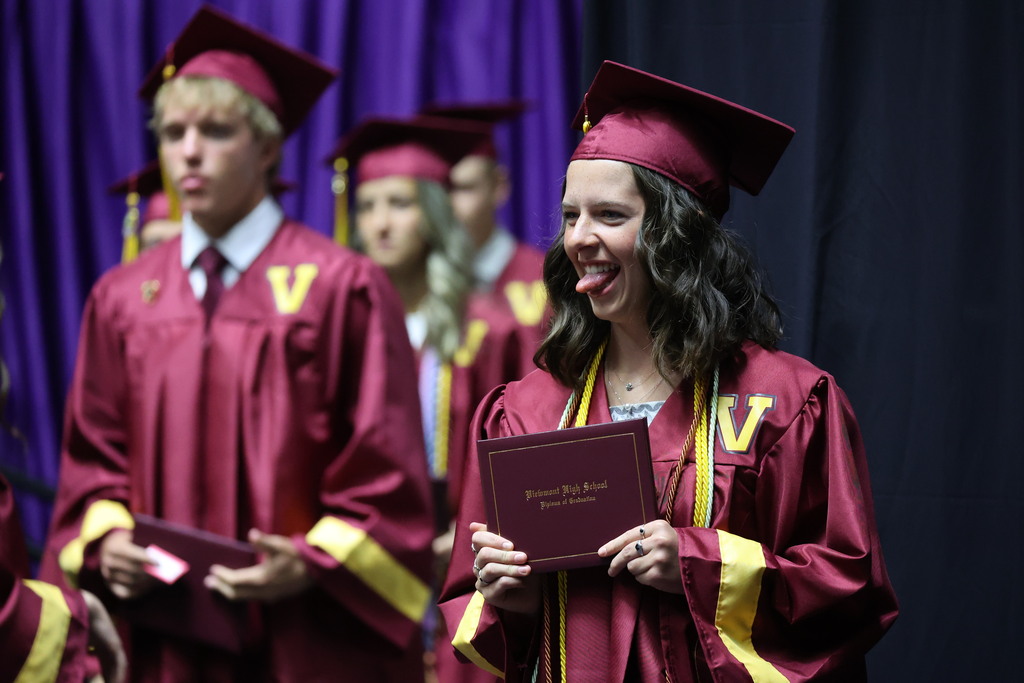 A Viewmont High graduate sticks out her tongue for a picture with her diploma cover. 
