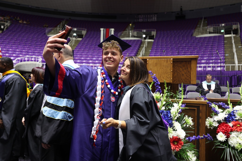 A Woods Cross graduate takes a selfie with their principal Jo Richins.