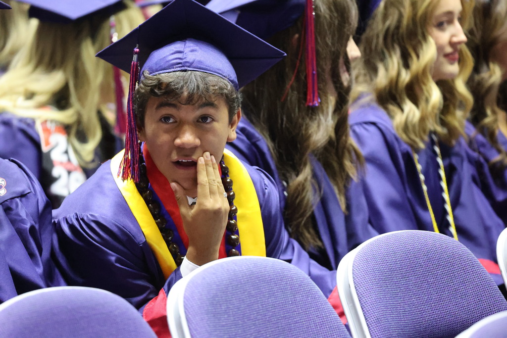 A Woods Cross graduate looks to the left in awe.