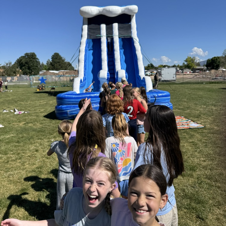 Kids sliding on a blow up toy  