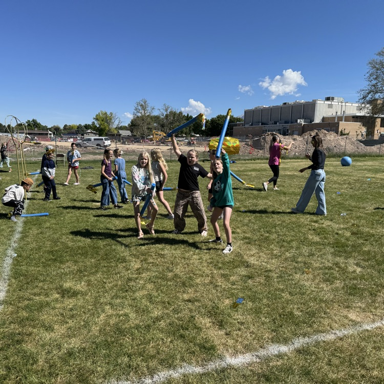 Kids playing Quidditch on the field  