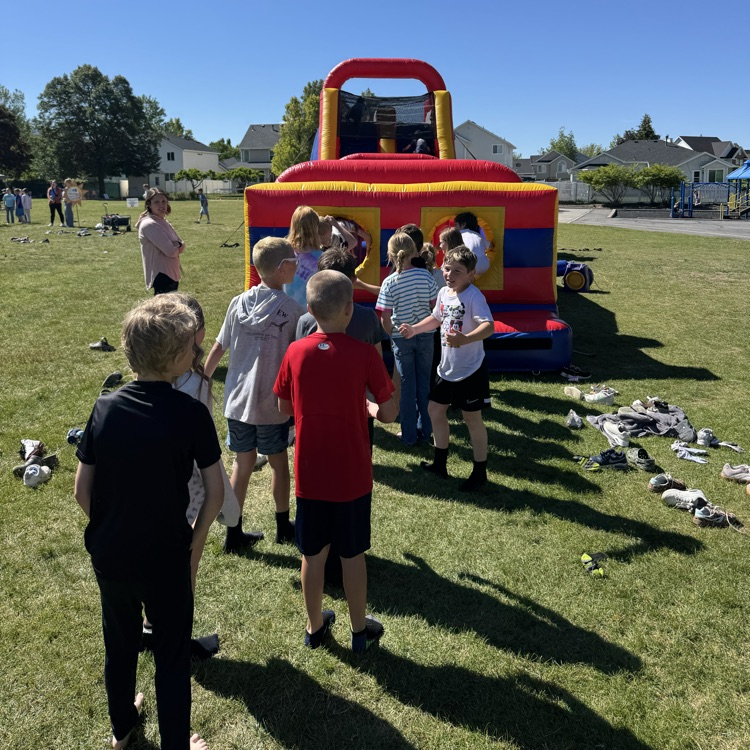 Kids playing on a blow up toy  