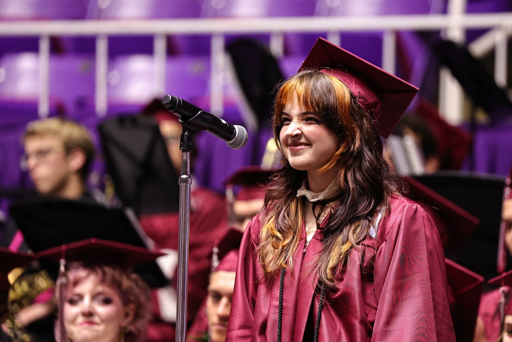 A Northridge High graduate smiles after performing during graduation.