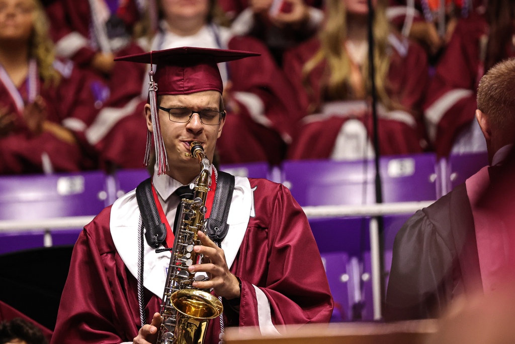 A Northridge High graduate plays the saxophone during graduation.