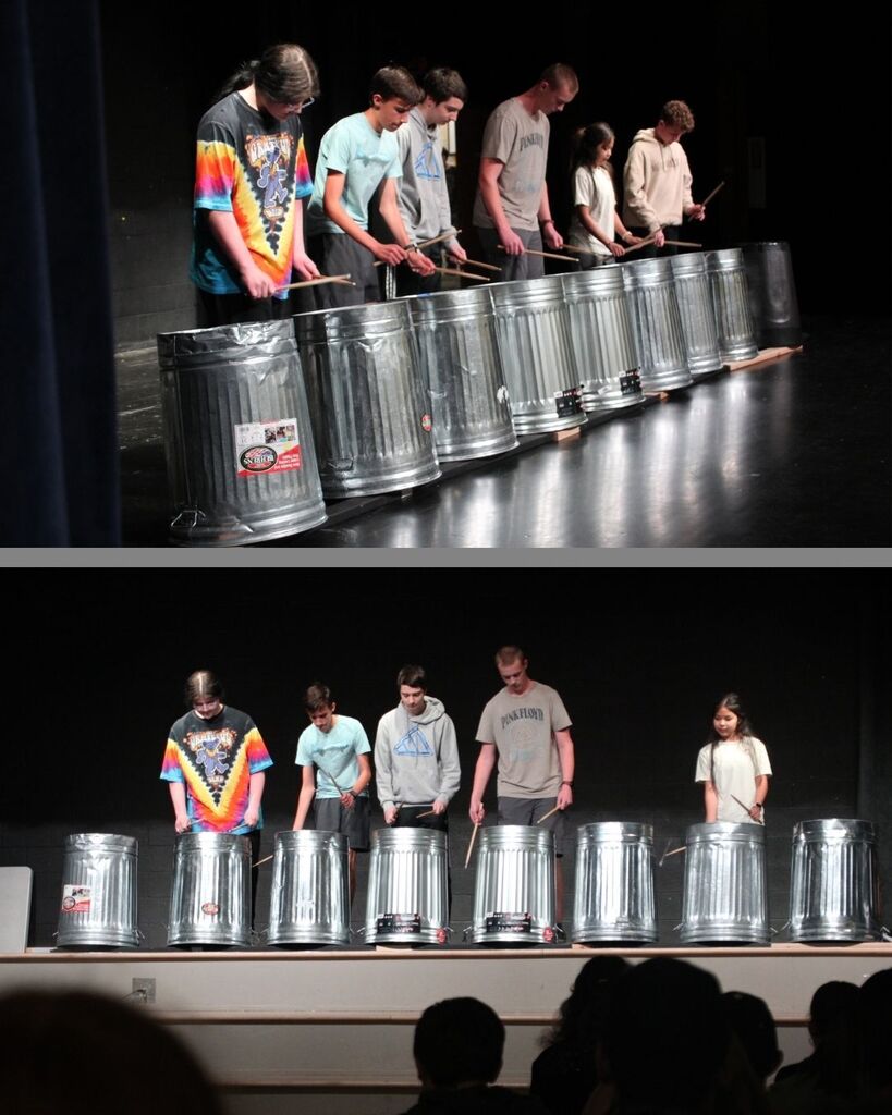Drummers from band playing upside down trash cans on stage