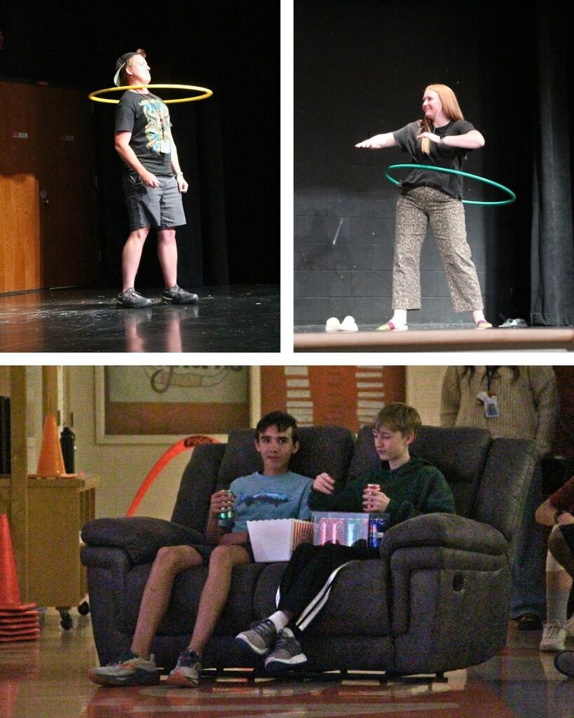 Teachers competing in a hula hoop contest on stage while two students sit on a couch in front row of the assembly