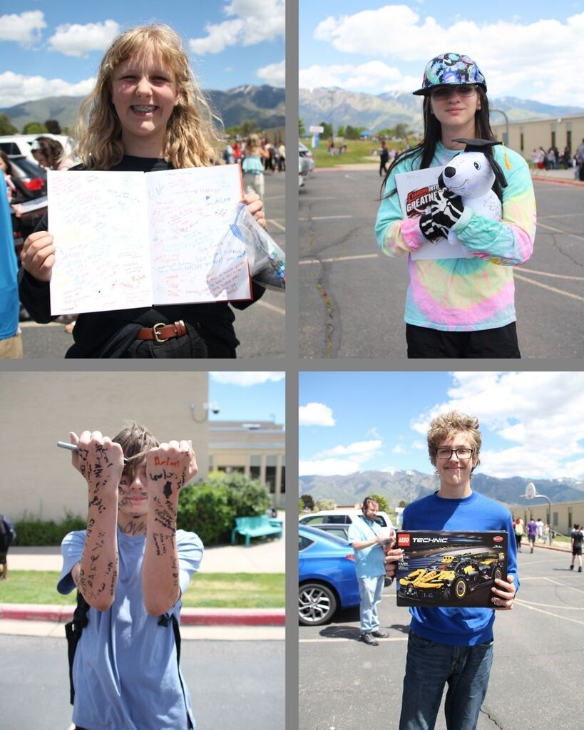 Four students stand outside signing yearbooks at the end of the school year