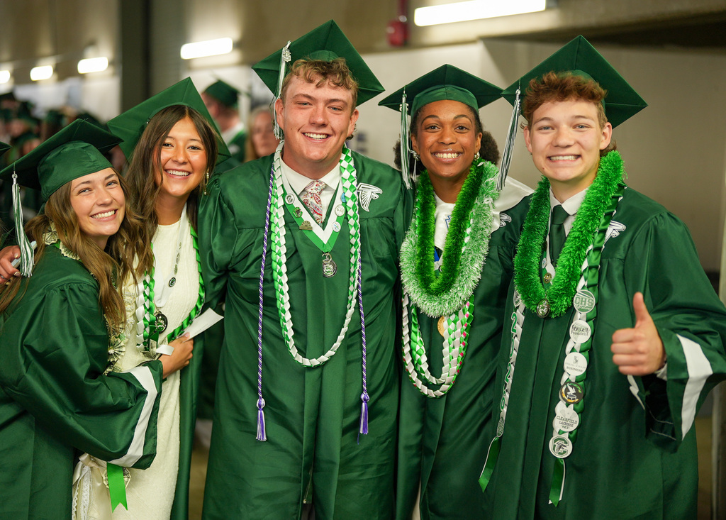 Clearfield High graduates smile at the camera.