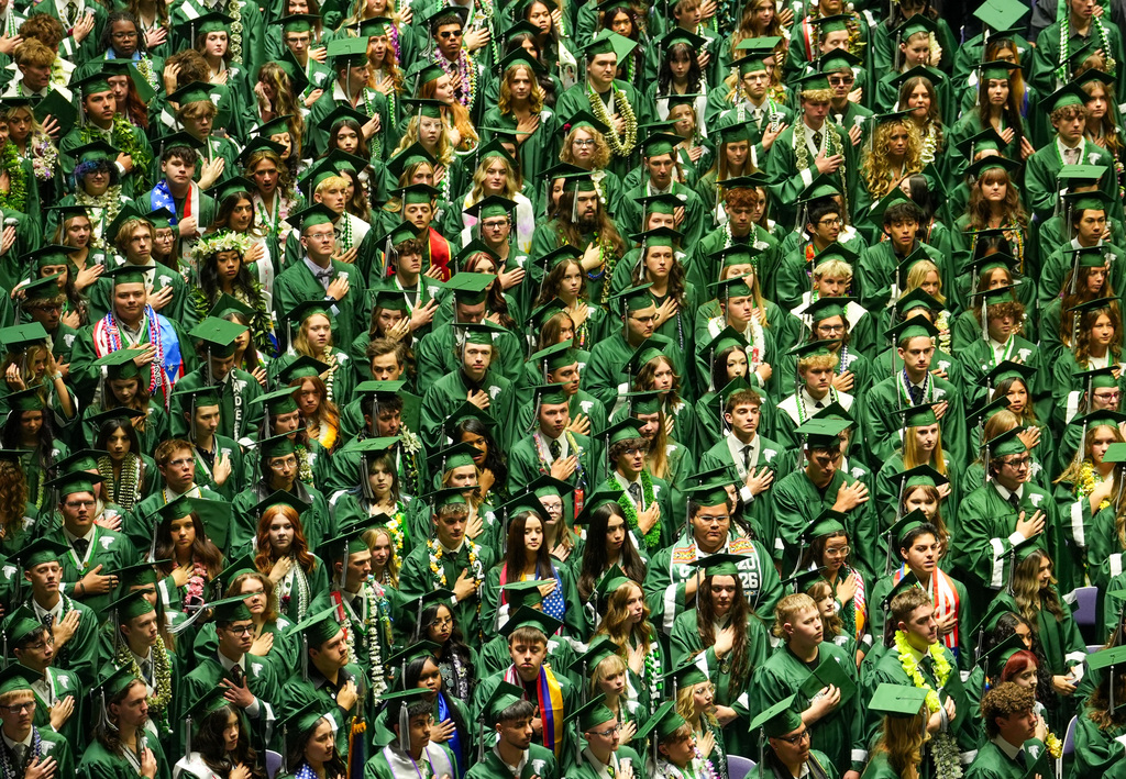 A crowd of Clearfield High students with their hands over their heart.
