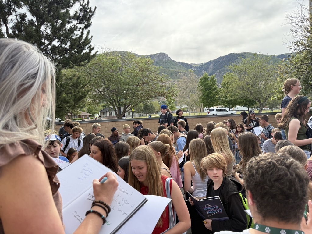 Mrs. Marker signing yearbooks with students. 