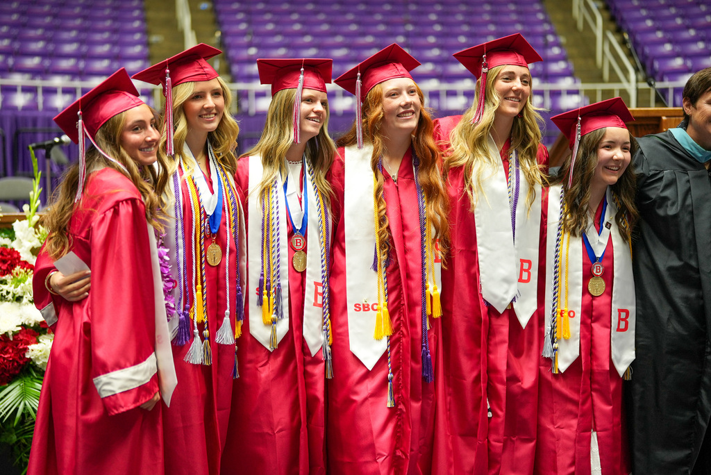 Bountiful High graduates standing together smiling.