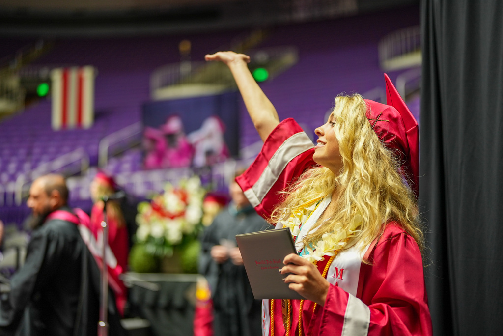 Bountiful High graduate puts arm in the air.