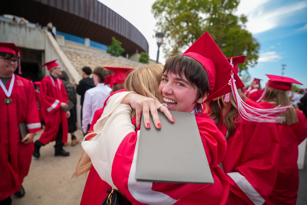 Bountiful High grad hugging someone.