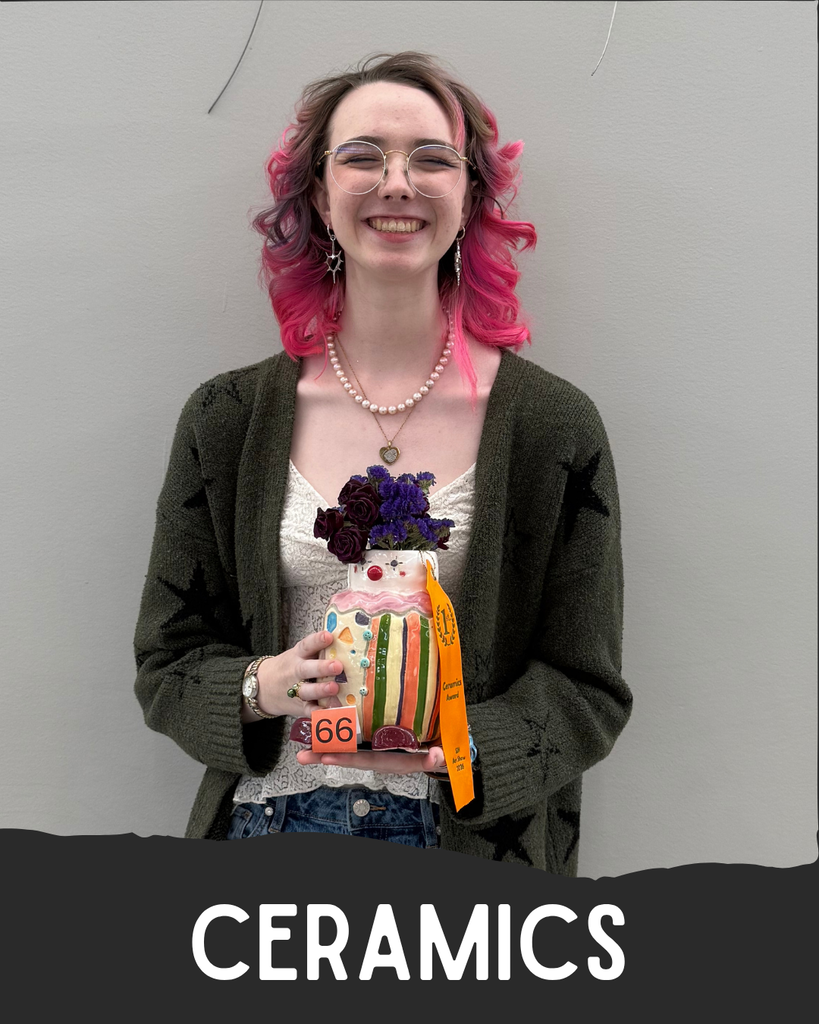 Student holding artwork.