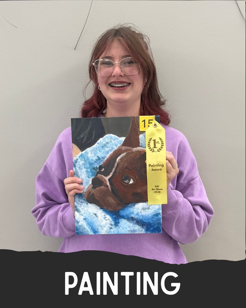 Student holding artwork.
