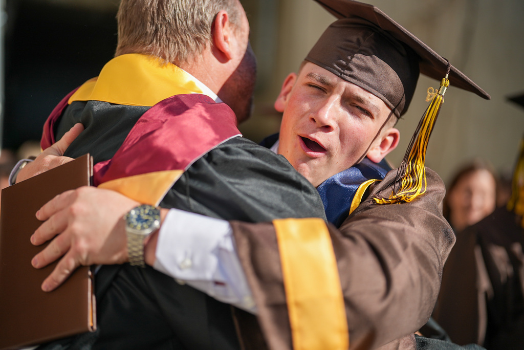 Davis High graduate hugs a teacher.