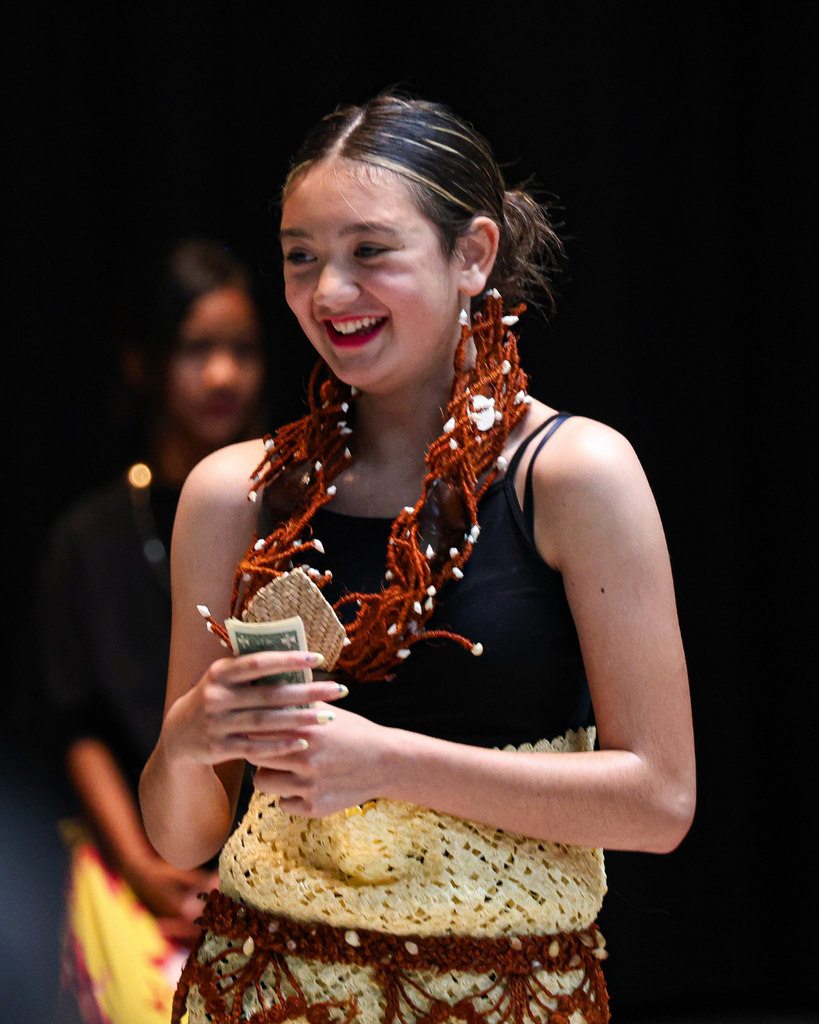 A Foxboro student dressed in heritage attire smiles.