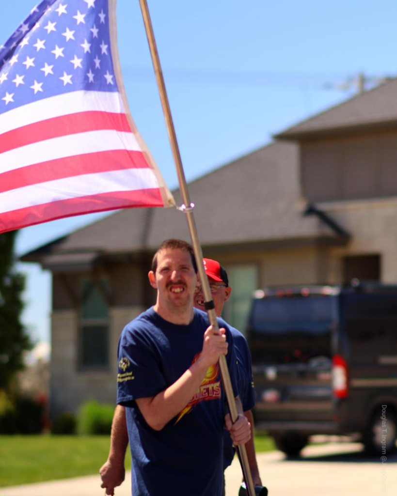 Someone holds up the American Flag.