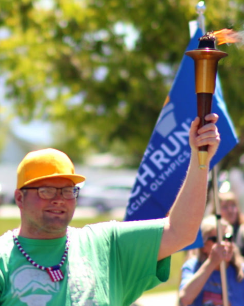 Someone holding a lit Olympic torch.