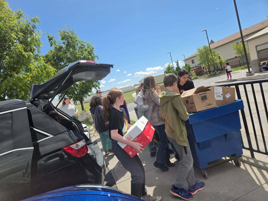 Students filling a cart with boxes