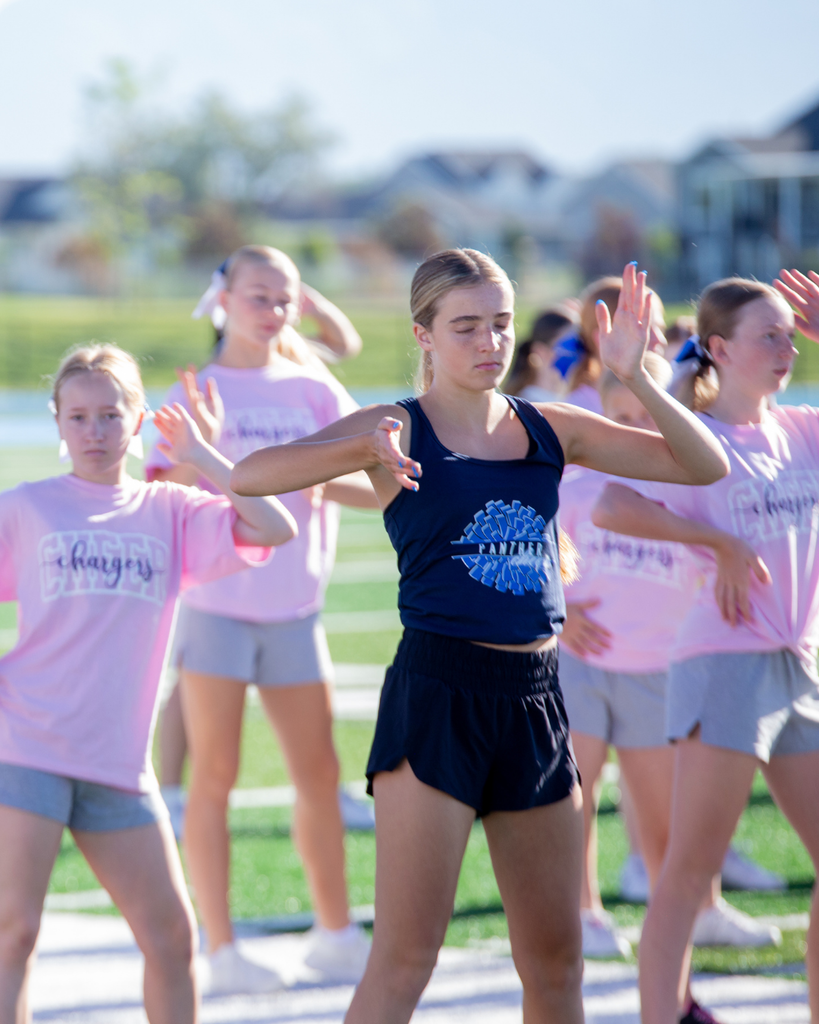 Cheerleader has eyes closed and is practicing her dance routine
