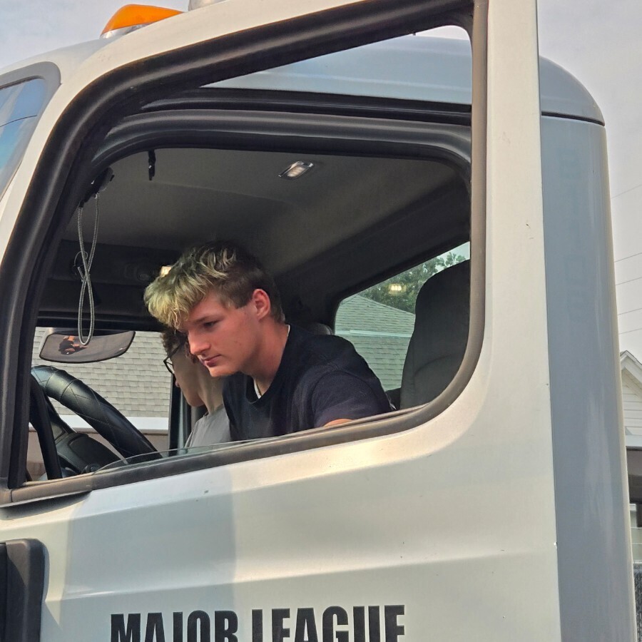 a male student getting out of a big rig truck