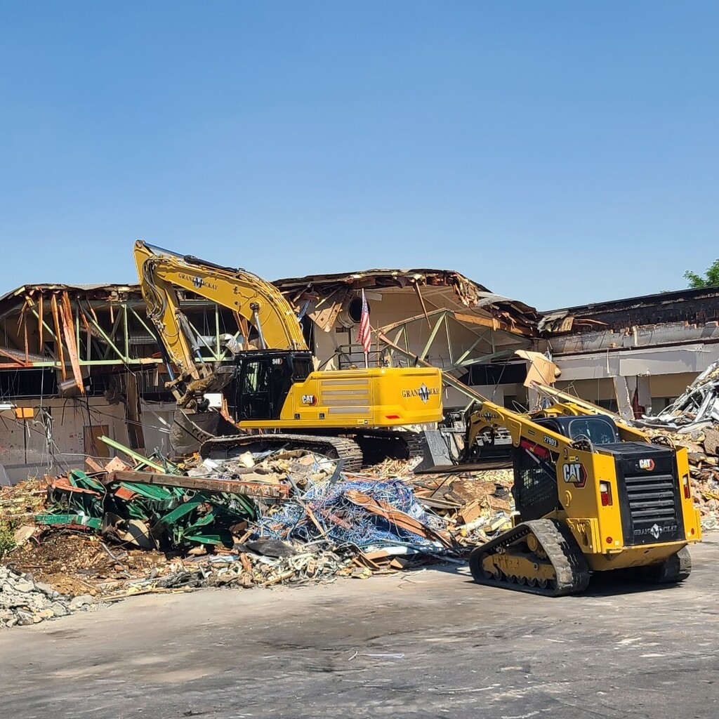 construction equipment demolishing building