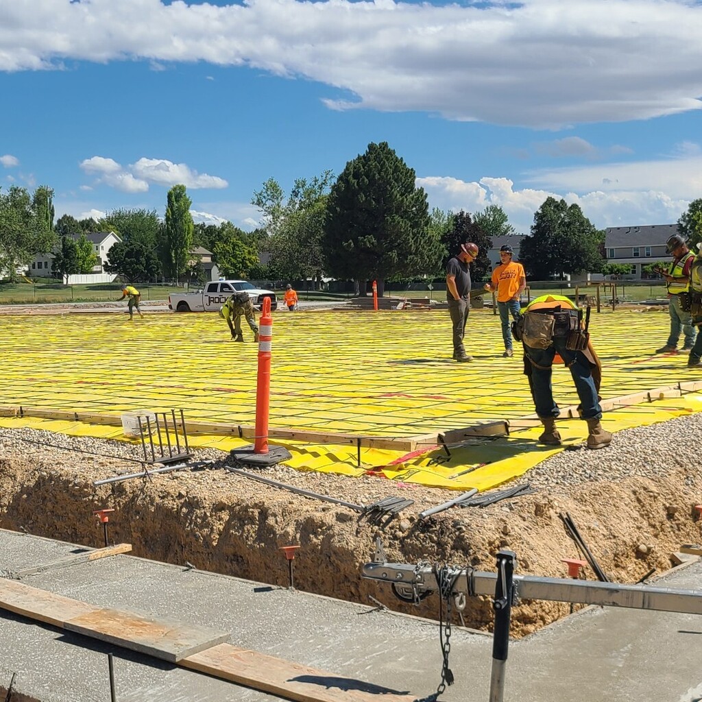 construction workers preparing for new concrete gym floor