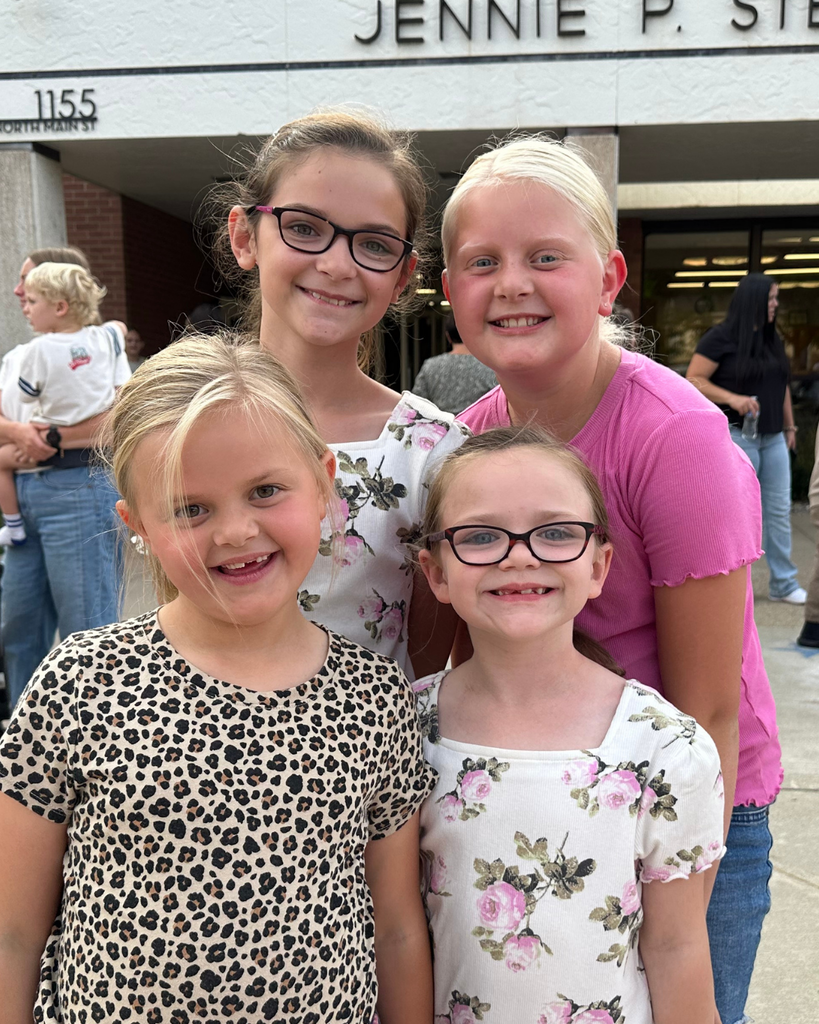 Four students smiling at the camera.