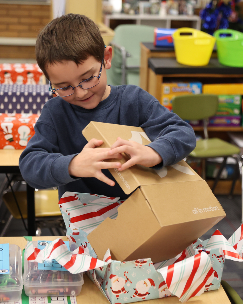 A student opening a wrapped box.