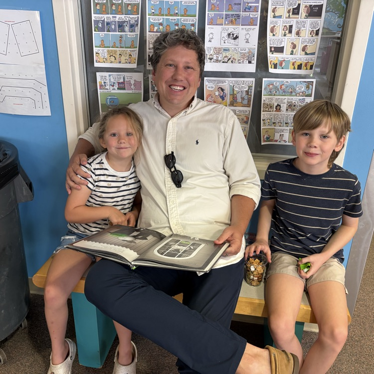 parent with 2 kids reading