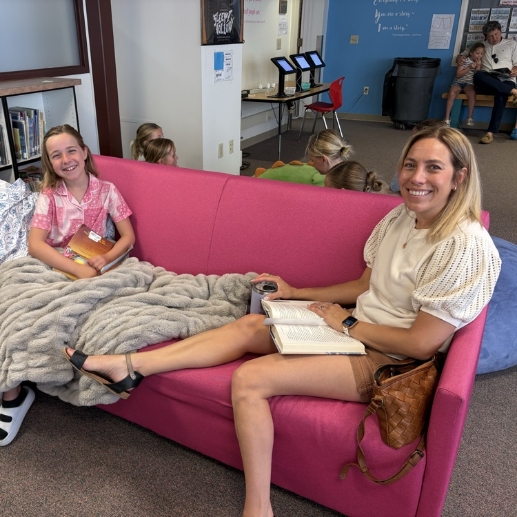 parents and child on couch reading