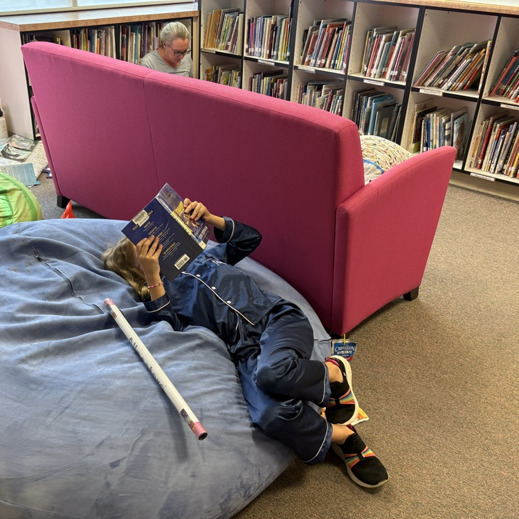 child on beanbag reading